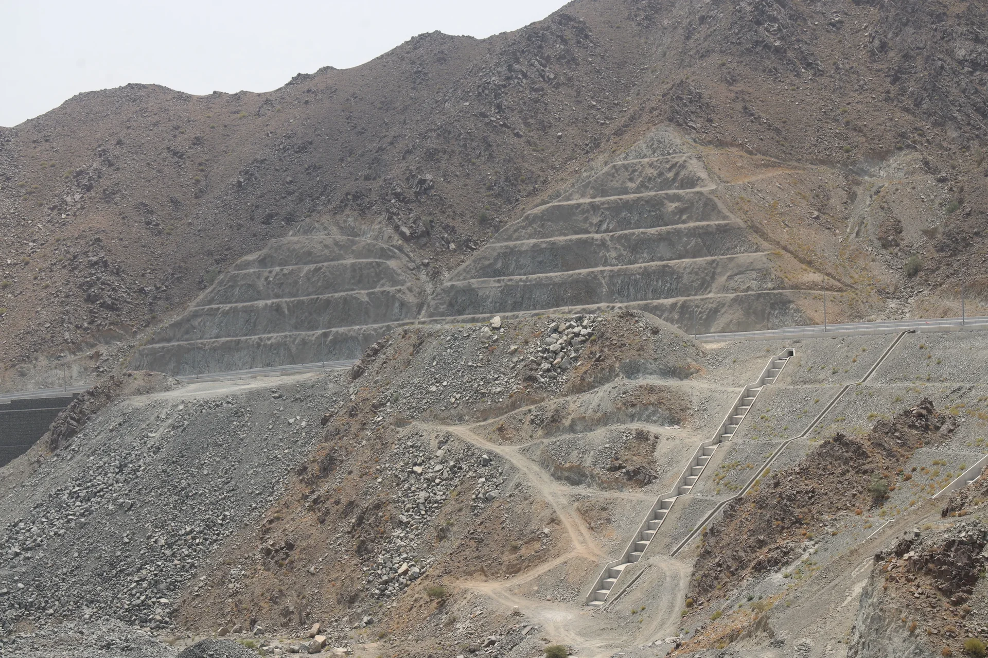Pyramid-benched rock cuttings and drainage cascade on Jabal Al Deem